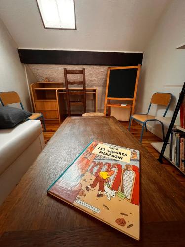 a book sitting on a table in a living room at Gîte de la petite Reine in Champagney