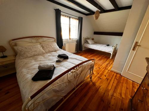 a bedroom with a bed with a phone on it at Gîte de la petite Reine in Champagney