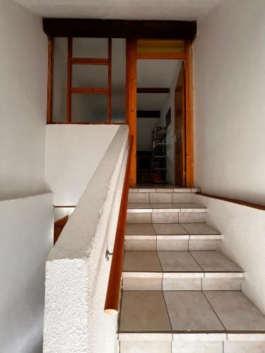 a stairway leading up to a door in a building at Gîte de la petite Reine in Champagney