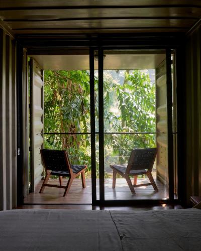 two chairs sitting on the porch of a house at River Pavilion, Kitulgala in Yatiyantota