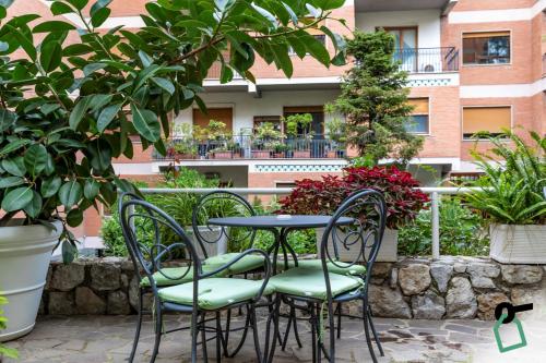 a table and chairs in a patio with plants at HOTIDAY Room Collection - Sorrento in Sorrento