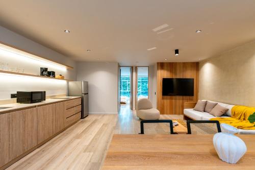 a living room with a couch and a tv at Spot Building - Apartments in Medellín