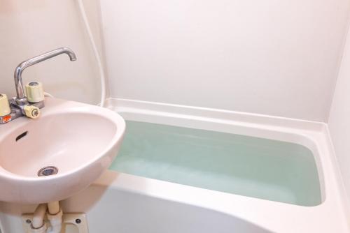 a bathroom with a sink and a bath tub at New! Japandi 3 1BR in Prime Location-1 min to STN in Hakata