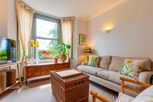 a living room with a couch and a tv at Pass the Keys Charming Victorian Terrace in centre of Cambridge in Cambridge