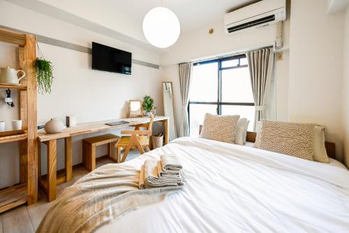 a bedroom with a white bed and a desk at New! Japandi 3 1BR in Prime Location-1 min to STN in Hakata