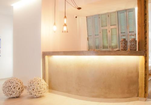 a metal counter in a room with two stools at Malibu Boutique Studios & Bungalows in Faliraki