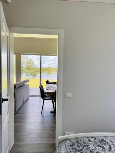 a bedroom with a bed and a desk and a table at Kaštonų krantas in Antotylʼtse