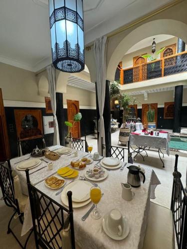 a dining room with a table with food on it at Riad Rodaina & SPA in Marrakech