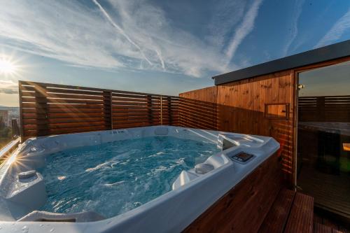 a jacuzzi tub sitting on top of a building at SkyLuxe Old Town Penthouse in Košice