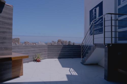 a balcony with stairs and a view of a city at Hotel San Martín in San Juan de Marcona