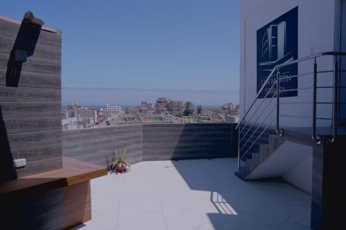 a balcony with stairs and a view of a city at Hotel San Martín in San Juan de Marcona