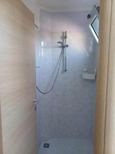 a bathroom with a shower with a glass door at Fuori dalle Mura Jesi in Iesi