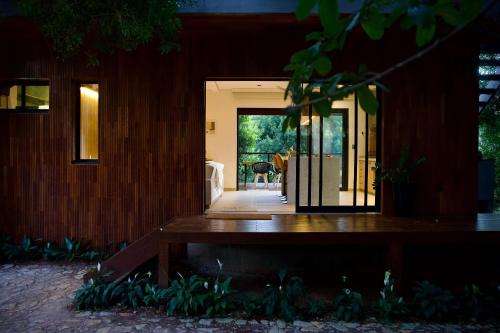 a house with a door open to a patio at Casa Nengueta - Lapinha da Serra in Santana do Riacho