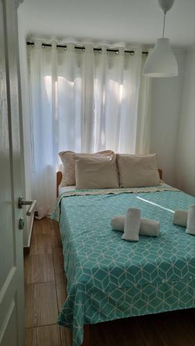 a bed with two pillows on it in a bedroom at Panonski raj in Palić