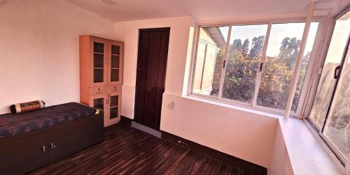 an empty room with a bed and a window at Suave 2bhk in Chennai