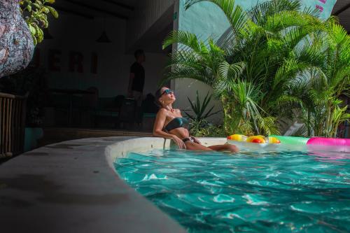 a woman in a bikini sitting in a swimming pool at Café Jeri Hotel - Adults Only in Jericoacoara