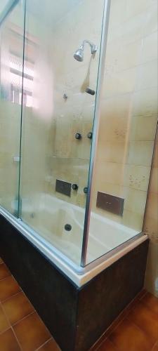 a glass shower with a sink and a faucet at Quarto na Praia de Copacabana, excelente localização! in Rio de Janeiro