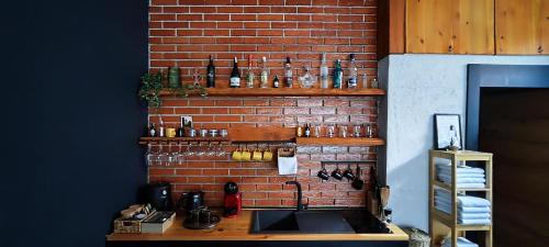 a kitchen with a sink and a brick wall at Oldtown Prishtina Apartments in Pristina