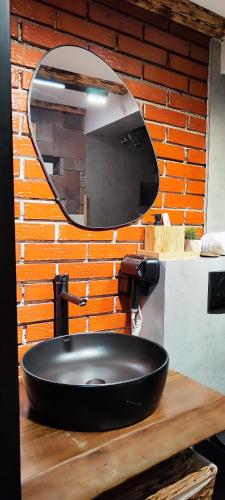 a bathroom with a black sink and a mirror at Oldtown Prishtina Apartments in Pristina