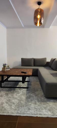 a living room with a couch and a table at Oldtown Prishtina Apartments in Pristina