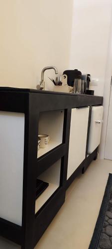 a kitchen with a black counter with a sink at Oldtown Prishtina Apartments in Pristina