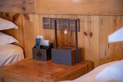 a wooden room with a bed and a table with a lamp at 张家界东篱山居民宿- Free pick up service in Zhangjiajie