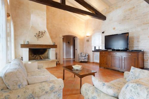 a living room with two couches and a flat screen tv at Villa Romana by Rent Istria in Višnjan