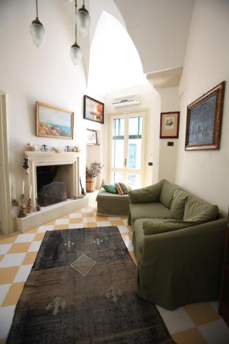 a living room with a couch and a fireplace at Palazzo Rollo in Lecce