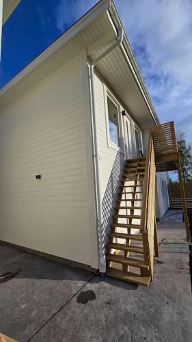 a house with stairs leading up to a garage at Nybyggd lägenhet i Vimmerby in Vimmerby