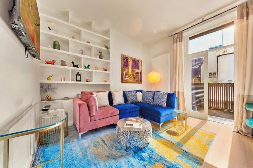 a living room with a couch and a table at DESIGNER Victorian Flat with HUGE Terrace in London