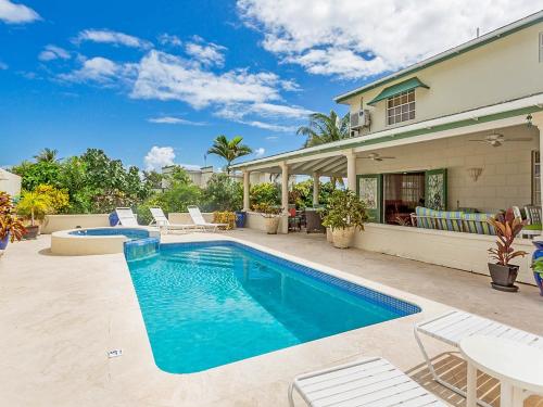 a swimming pool in the backyard of a house at Ocean View home by Bluescape in Saint Philip