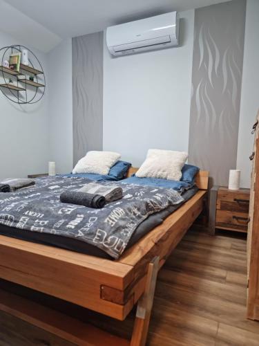 a bedroom with a wooden bed with a mattressvisorvisor at We love Tokaj cottage in Tokaj