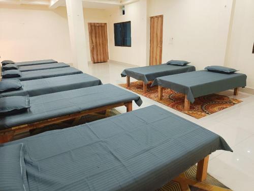 a row of blue tables in a room at The Royal Sahdeo Venue in Gaya