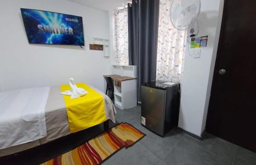a small room with a bed and a yellow table at Hotel San Martín in San Juan de Marcona