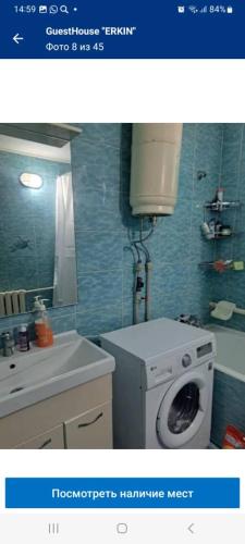 a bathroom with a washing machine and a sink at Hostel Erkin in Karakol