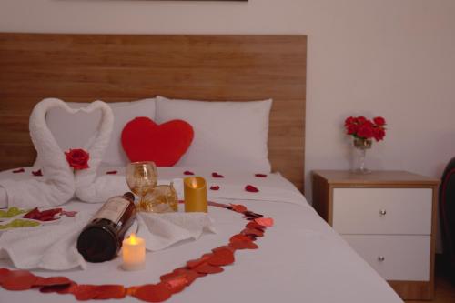 a bed with red roses and candles and a heart on it at Hotel San Martín in San Juan de Marcona