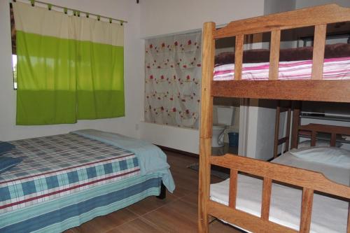 a bedroom with two bunk beds and a bed at Chácara Recanto dos Pássaros in São Thomé das Letras
