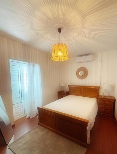 a bedroom with a bed and a ceiling at Casa do Rossio in Fornos