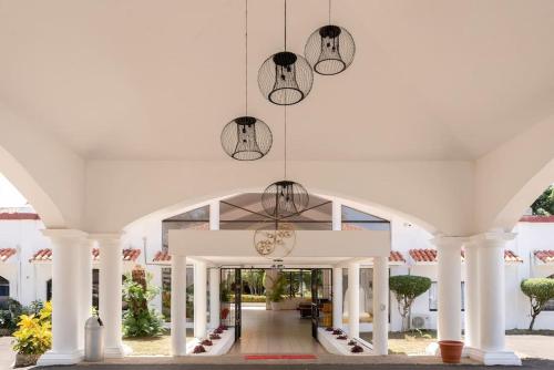 a white building with two chandeliers hanging from it at Flat Sea & Sun Monte Vista in Sosúa