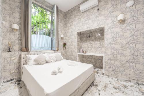 a bedroom with a large white bed with a window at Duomo Smart Suites in Milan