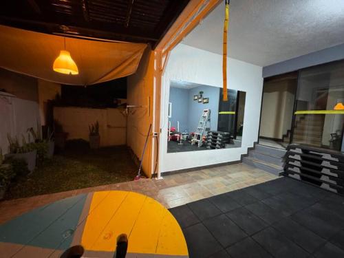 a room with a view of a house with a large window at Apartamento Totalmente Equipado in Mixco