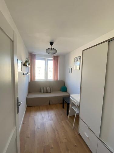 a living room with a couch and a window at Może nad morze in Gdańsk