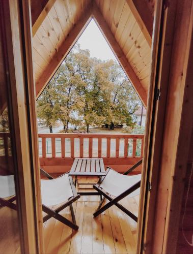 a view of a porch with two chairs and a table at Brvnara Mila Vinci in Golubac