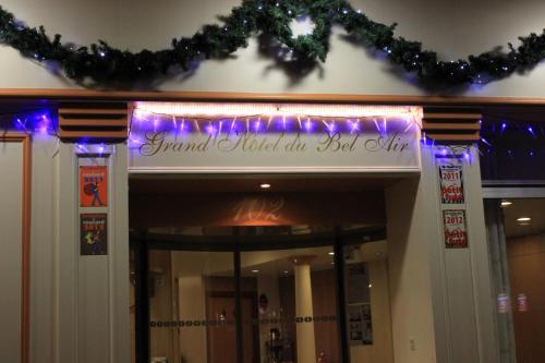 a sign on the front of a building with purple lights at Grand Hôtel du Bel Air in Paris