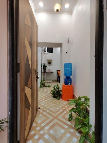 a hallway with a door and a room with plants at A ShivAngan Heritage Home Stay Near Ghat in Varanasi