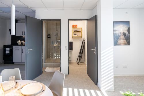 a dining room with a table and chairs at Hygge Homes - Cube Apartment in Borstel