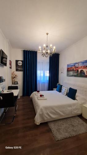 a bedroom with a large bed and a chandelier at Appartamento Natalia Verona in Verona