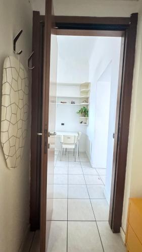 a door leading into a dining room with a table at Sawasdee 37 in Monza