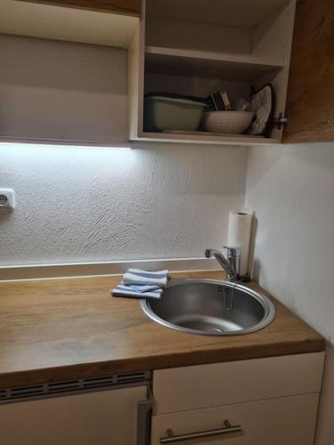 a kitchen counter with a sink and some dishes at Schöne Appartement-Wohnung in Frixheim