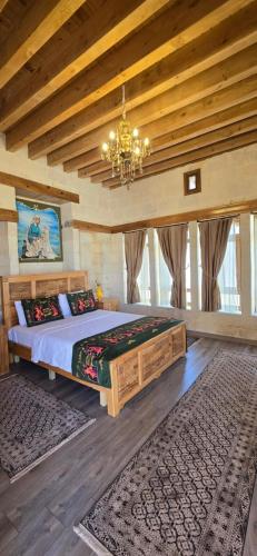 a bedroom with a large bed and a chandelier at nahrin hote & art in Sanlıurfa